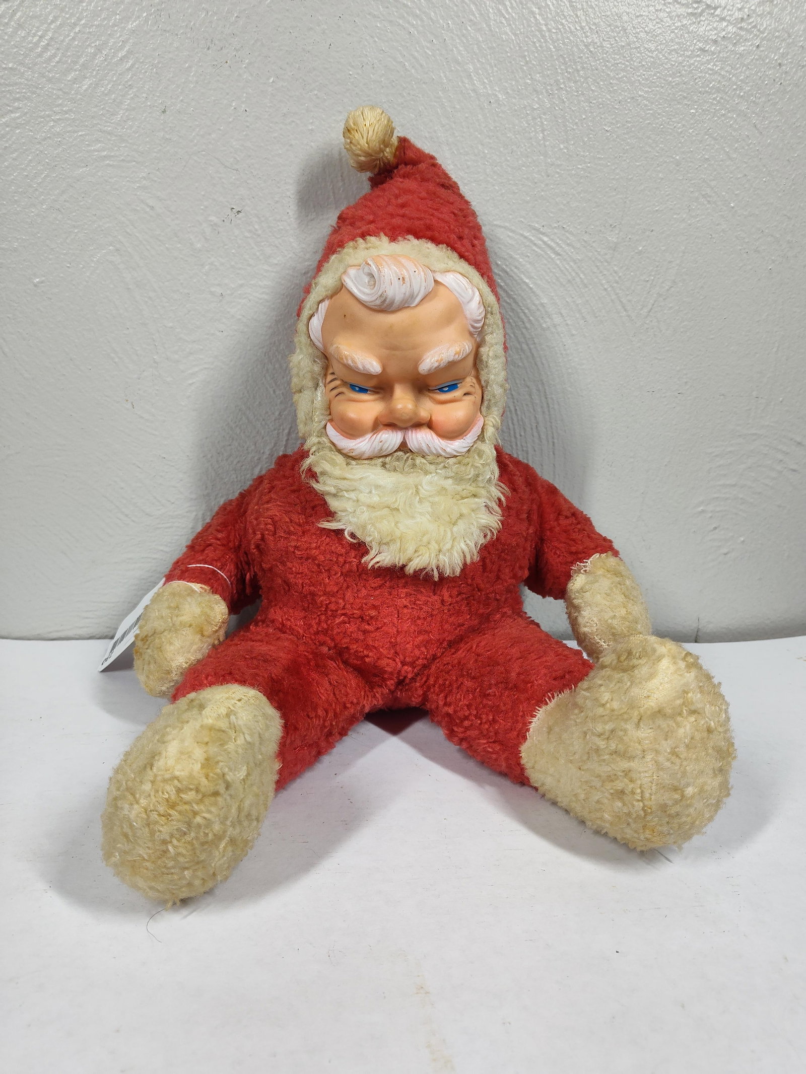 1950s Plush Rubber Face Santa: Shows some discoloration from age but is free of holes or major damage. Face is in good condition. Approx 16 inches.