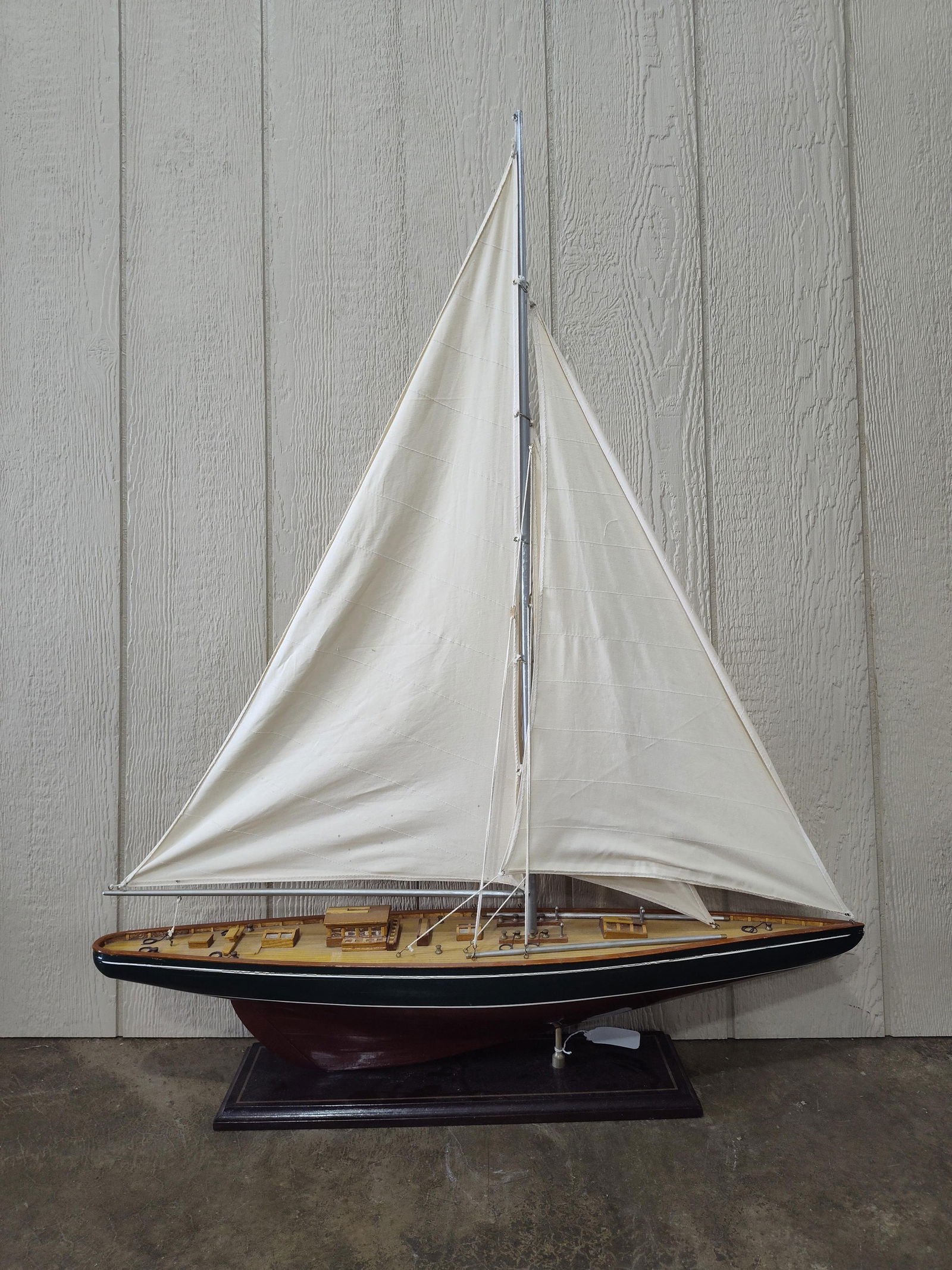 Excellent Model Sailboat: Fabric sails, wood carved detail, with brass parts. Beautiful 36 inch long boat on base. 43 inches tall