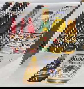 Beer Bottle Advertising Signs: Tennents of Scotland Plastic signs 22.5x6, Tin Corona 22x6, Modelo 16x9, Negra Modelo 15x5.5, and Wicked Ale 24x6.5.