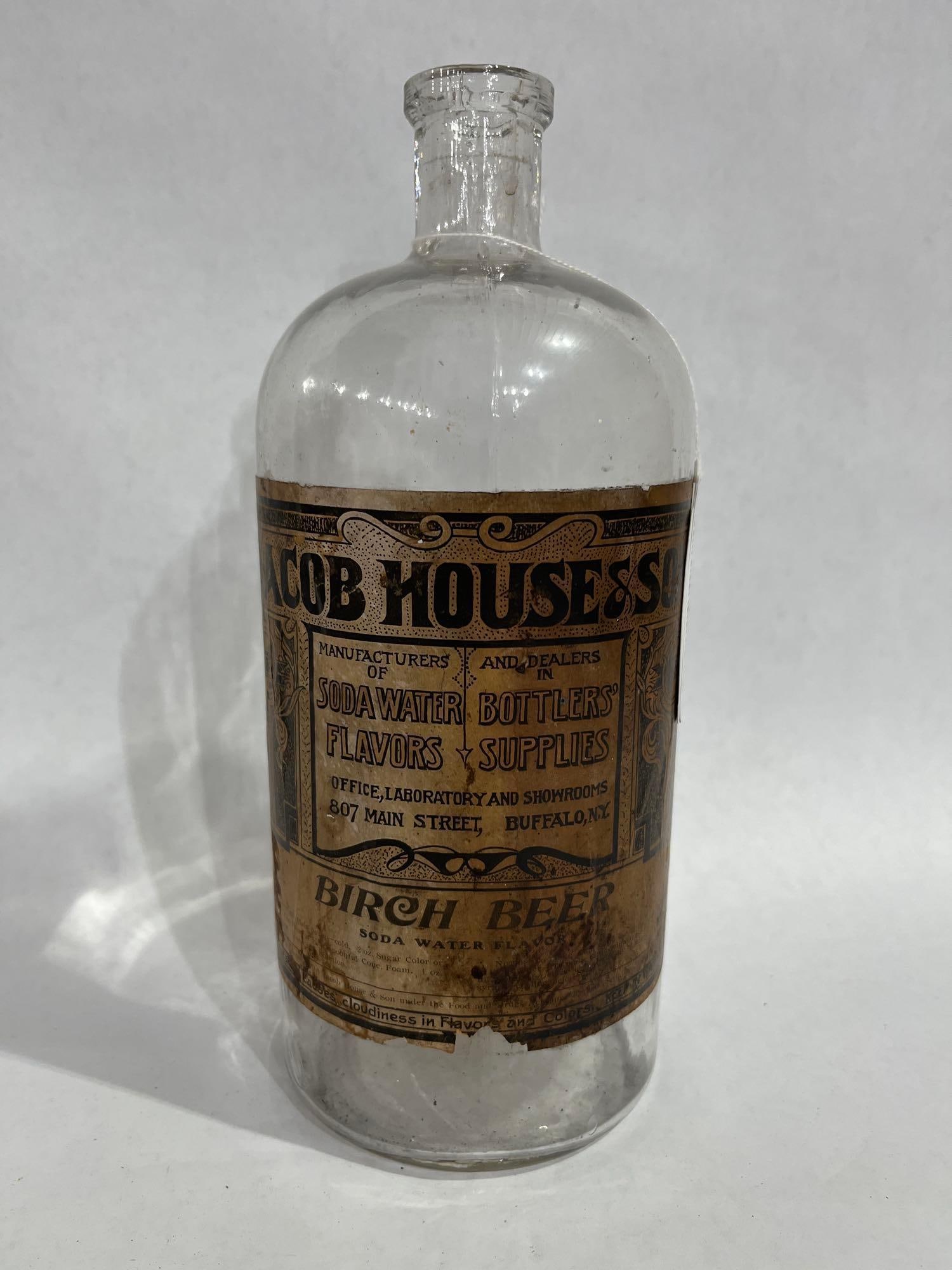 Jacobs House & Son Birch Beer Bottle: Paper label to large clear glass bottle. 11 inches tall. No chipping or cracks
