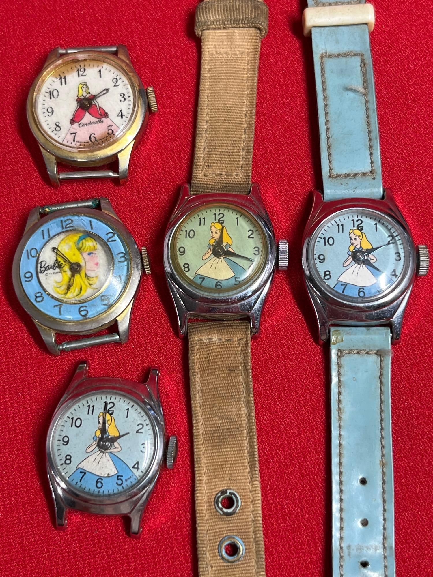 Cinderella, Barbie, and Alice in Wonderland Wrist Watches: Several are just faces. Barbie watch is running.