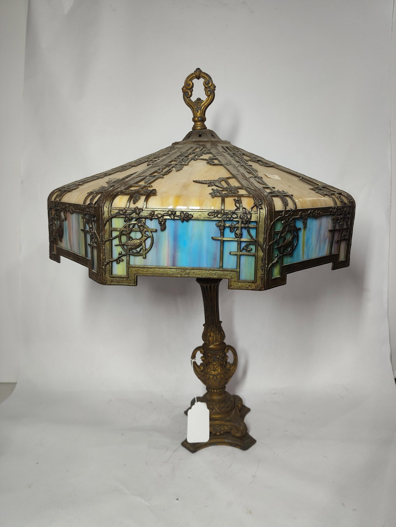 Slag Glass Framed Lamp: One panel is missing and top shows a slight dip. Top finial can not be attached. Wiring has been removed. Approx 22x19