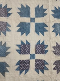 Hand stitched blue floral Bear Paw block quilt