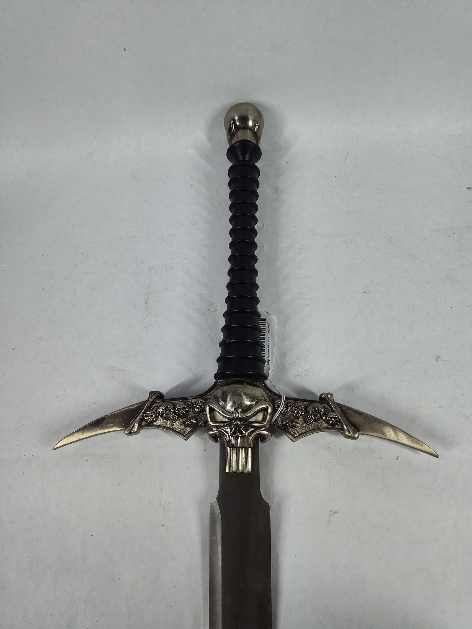 Punisher Skull Sword: Featuring bat wings, and skull on handle and pommel. Stainless blade. 51 inches long.