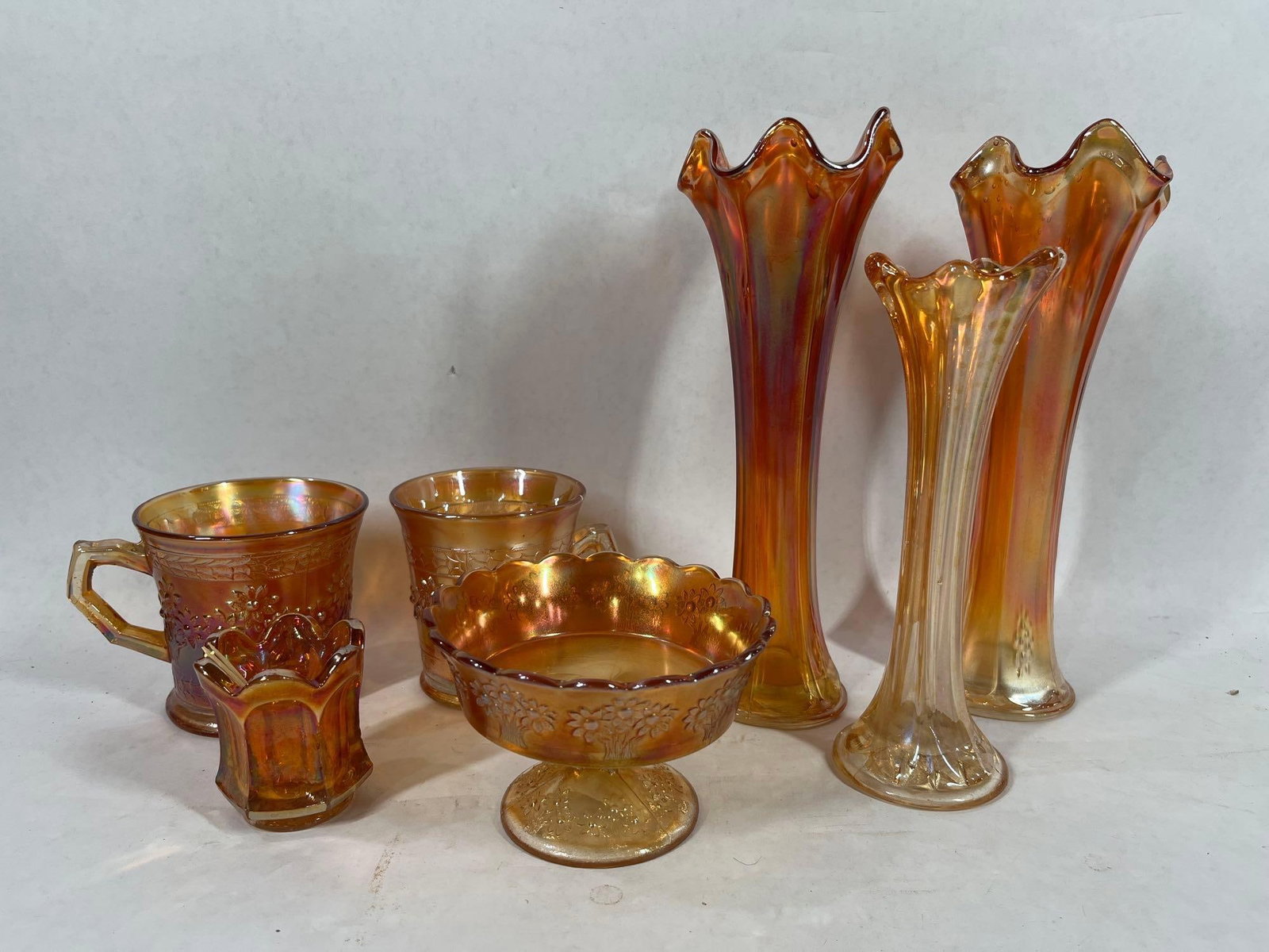 Indiana and Fenton Marigold Glass: Includes three vases0 9.5, 9, and 7 inches tall. All pieces seem to be in good condition with no chipping or cracks. 7 total glass pieces.