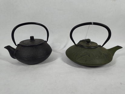 Wonderful Pair of Cast Iron Tea Kettles: Green stained kettle is decorated with bamboo embossing. 7 inch diameter. Black kettle is 5 inches in diameter