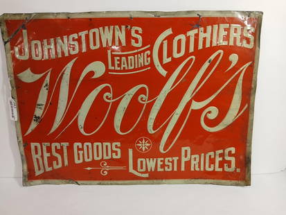 Woolfs Clothing SST Johnstown Ohio Sign: A wonderful early clothing embossed sign. Several bends, dings, and spots throughout. 28x20. Standard Adv. Co, Coshocton O. Louisville, KY. This awesome sign is an original piece. Found tucked away in