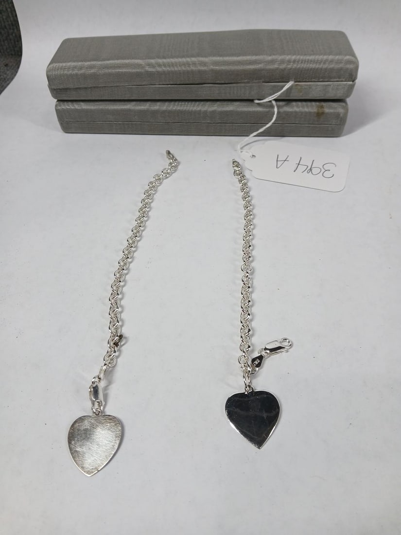 Sterling Silver Bracelets: Two with heart shaped charms.