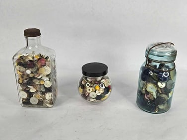 Blue jar and bottles filled with vintage buttons