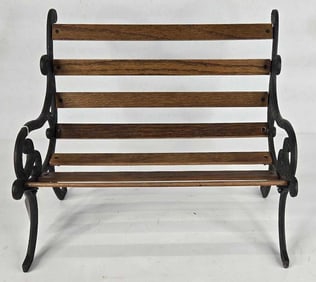 Miniature cast iron legged wood slatted park bench