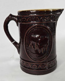 Victorian brown glaze cow decorated stoneware pitcher