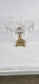 Ornate crystal bowl with brass pedestal base and prisms