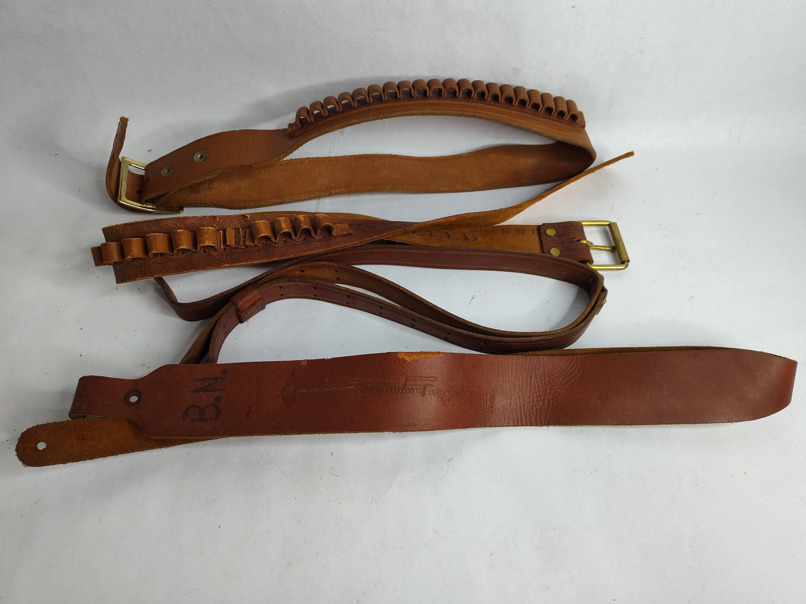 Brown leather cartridge belts and rifle slings: 32 to 40 in waist on belts