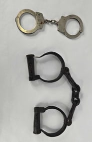 Antique handcuffs and Smith & Wesson handcuffs