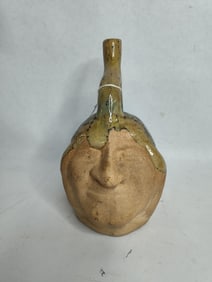 Clay pottery face jug