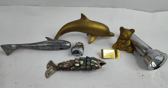 Brass dolphin,bear, money clip, fish bottle openers and eveready captain flashlight