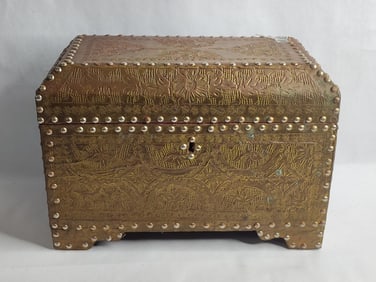 17th Century stamped brass covered wood trunk featuring intricate embossing and studded details