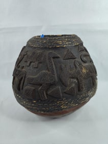 1800's hand carved bulbous vessel depicting anthropomorphic characters used for transporting water
