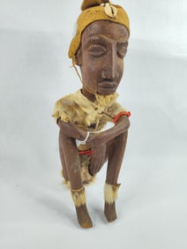 African Gurunsi tribal sculpture of seated hunter wearing fur/hide