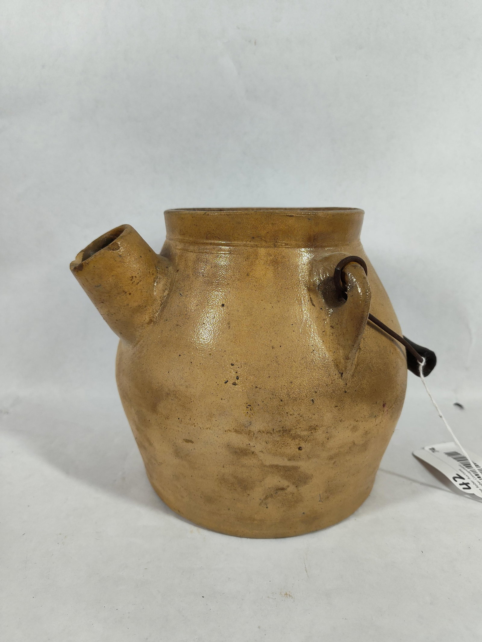 Havana Ny Batter Crock: 7 inch tall crock shows some minor chipping to spout, handles and base. A hairline crack to back side with a primitive wooden handle.