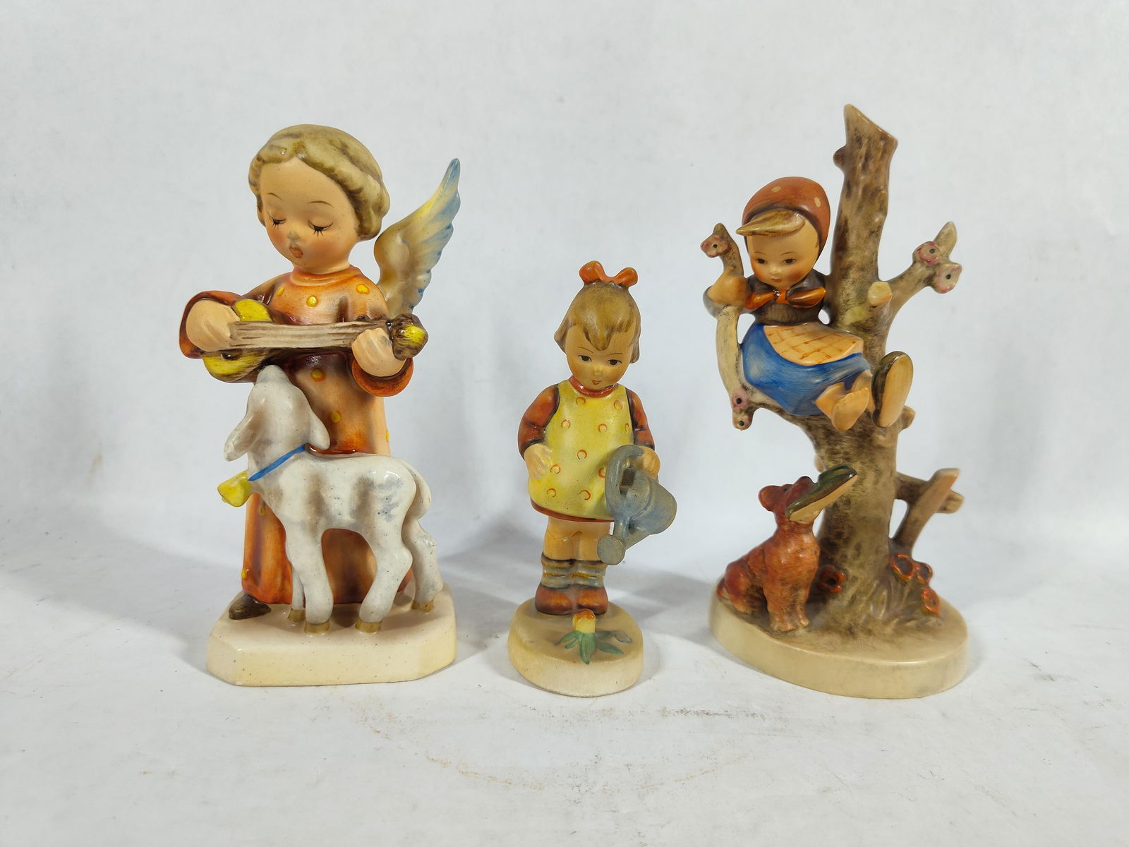 Goebel Hummel Figurines: Angel serenade #89, Little Gardener , and Out of Danger # 56B. All are in good condition