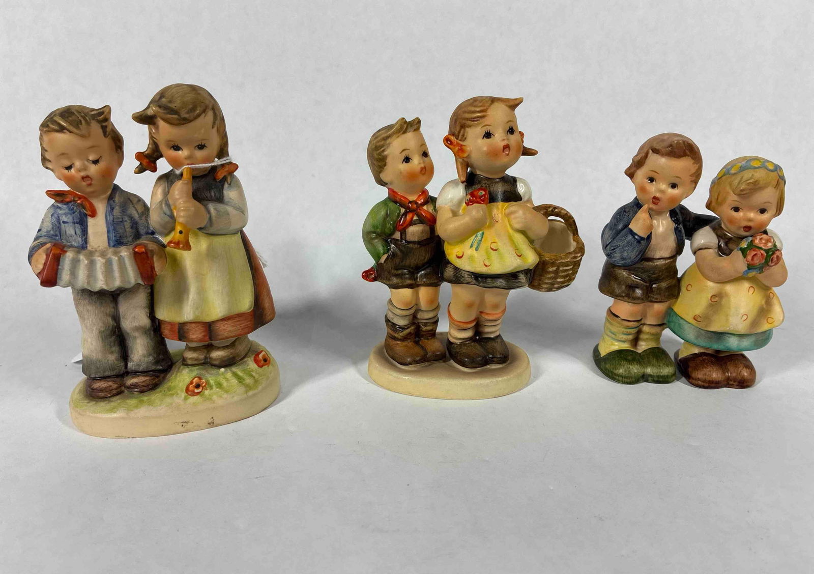 Goebel Hummels: Birthday Serenade 1985, To Market 49 3/9, and Congratulate signed. Approx 4.5 inches tall