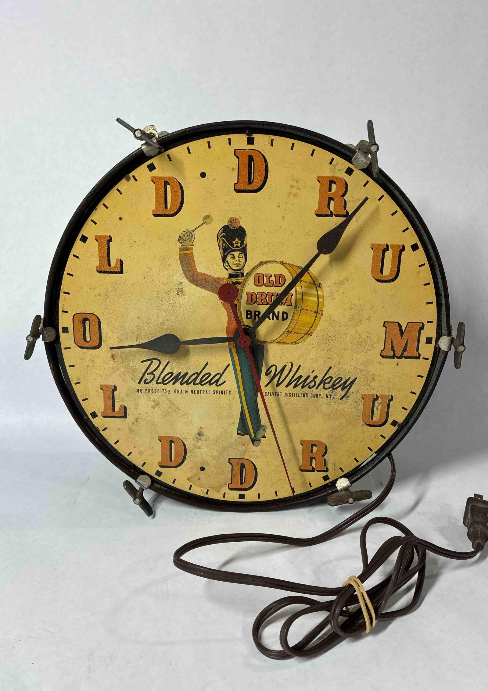 Old Drum Brand Whiskey Clock: Cute drummer boy image to front. Made by MacLaren Action Signs. 12 inches in diameter. Clock is in working condition