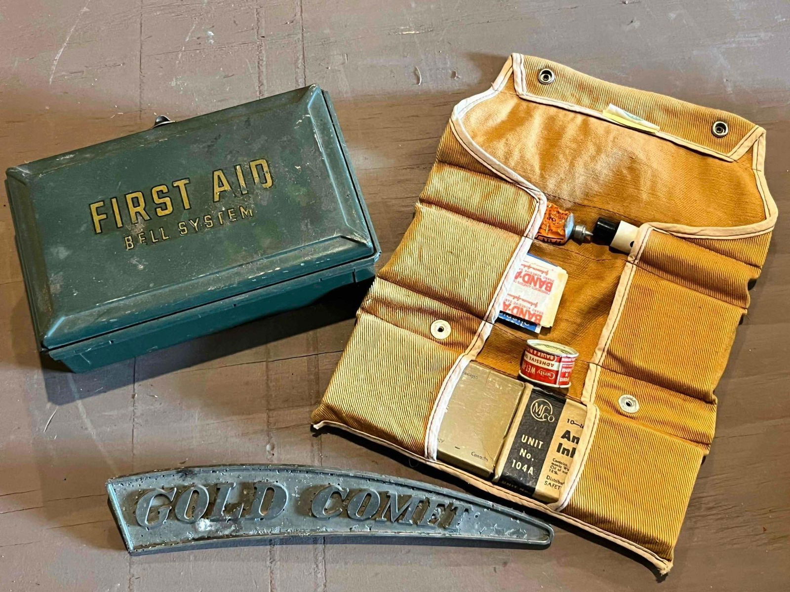 GOLD COMET EMBLEM AND FIRST AID KITS: .