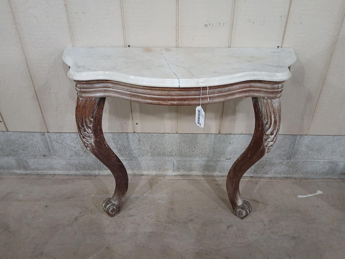 Marble Top Half Entryway Table: Carved legs. Marble top shows a repaired crack. This half table needs to be fixed to a wall, 2 legged. 34x13x27
