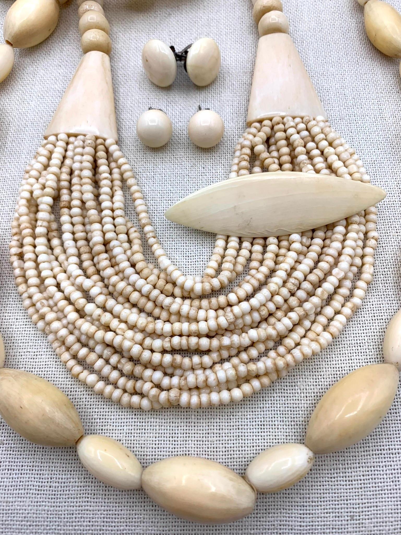 8 pc Natural and Created Material Jewelry Collection: 32" polished bead necklace, 15 strand bone bead collar necklace with hook closure (16" neck circumference), 2 5/8" marquise shaped brooch with working pin.