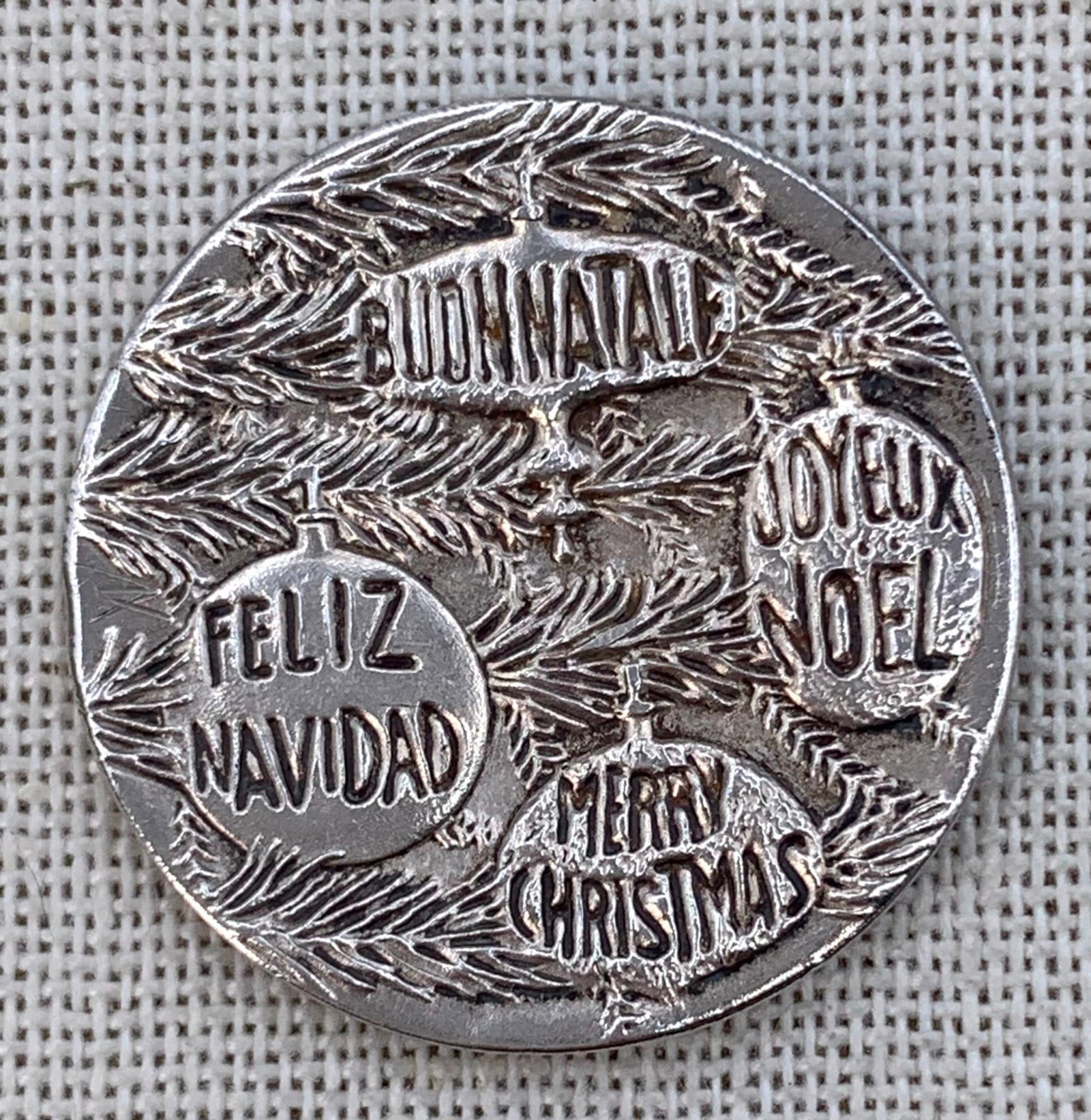 1975 Sterling Silver Bilingual F A O Christmas Greeting Medallion: Hallmarked along the rim, 13.8 gram weight, 30mm in size, embossed on both sides.