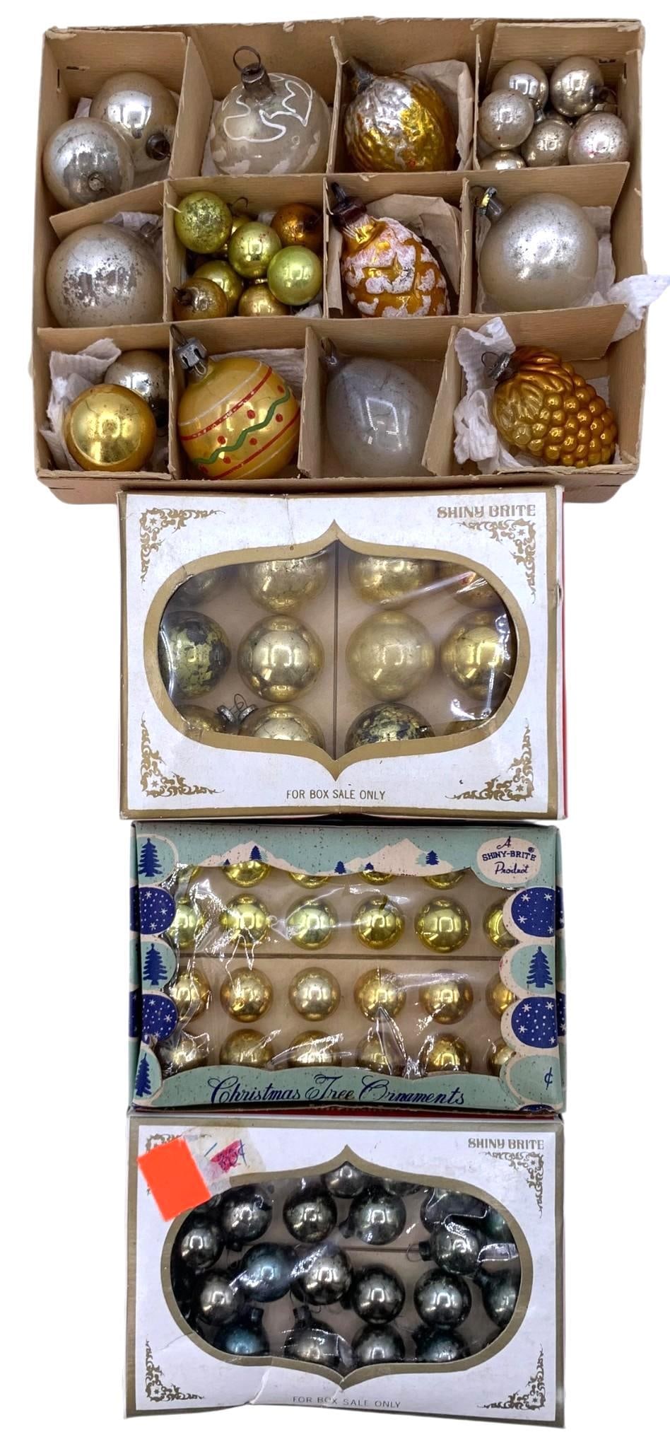 88 pc Vintage Gold and Silver Mercury Glass Ornaments in Petite Shiny Brite Ornament Boxes: Trio of small Shiny Brite boxes and the base of a West Germany ornament box hold petite gold, silver and smoke gray mercury glass ornaments, a few do not have the metal caps, 1/2" to 2 3/8".