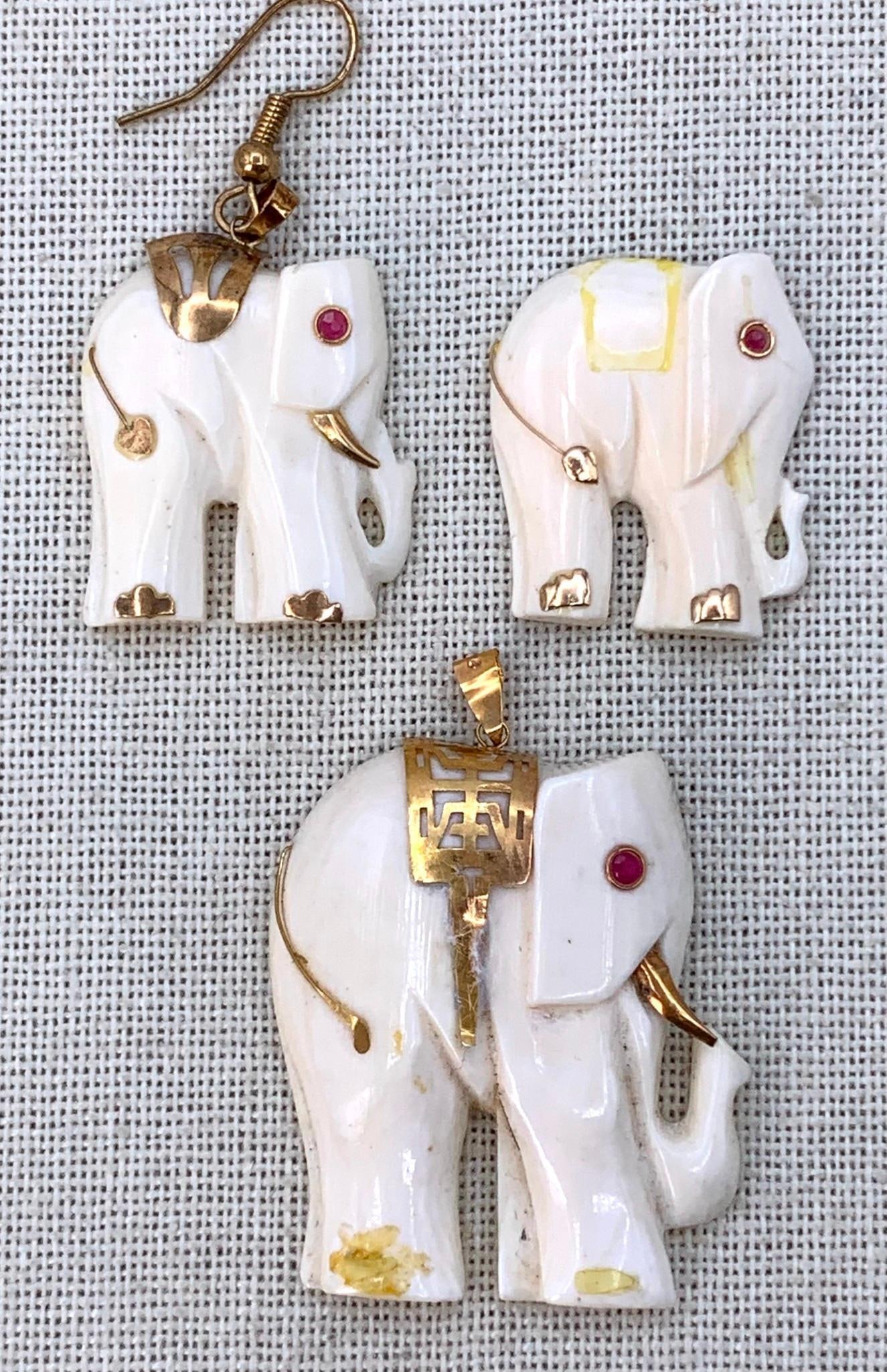 3 14k Gold and Ruby Adorned Carved Elephant Effigy Pendants: 14k 585 hallmarks, inlaid petite Ruby gemstones, missing Gold tusk and back adornment on one carving, missing foot trim on the 2" pendant, added earring hook to one of the 1 1/8" pendants as shown.&nb
