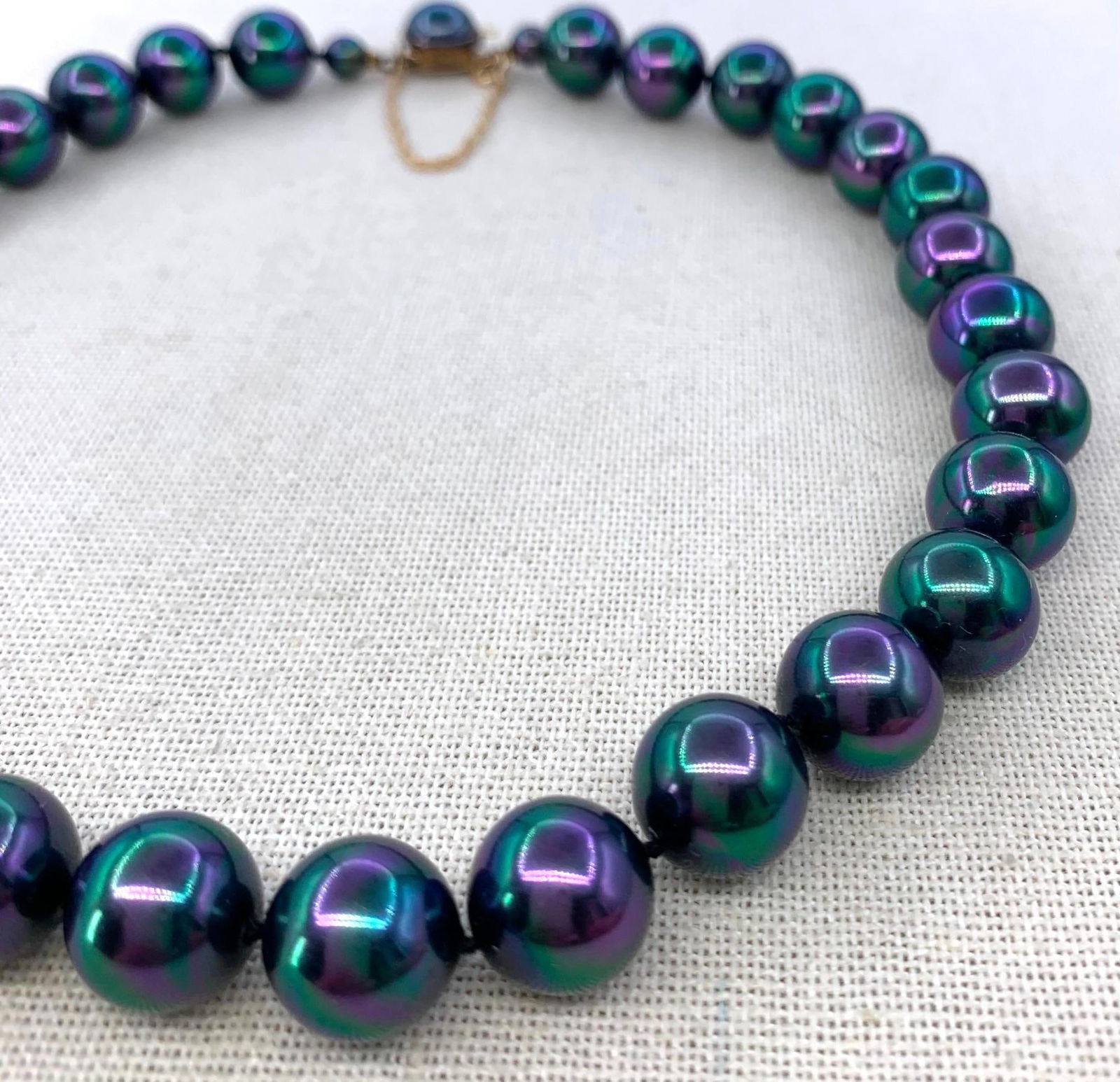 Incredible Mid Century 12mm Peacock Spanish Majorica Created Black Pearl Necklace, 14k, 925 Clasp: 14k hallmarked gold safety chain, 925 hallmarked clasp, huge 12mm glass pearls with superior peacock, plum and emerald hues, Majorica paperwork, 16" circumference, Gorgeous! 