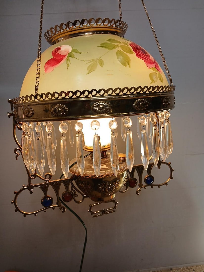 Hand Painted Rose Pull Down Jeweled Lamp: Crystal glass prisms and jewels on brass body. Painted shade is 15 inches. Once was an oil lamp but has been converted to electric. Great working condition. 