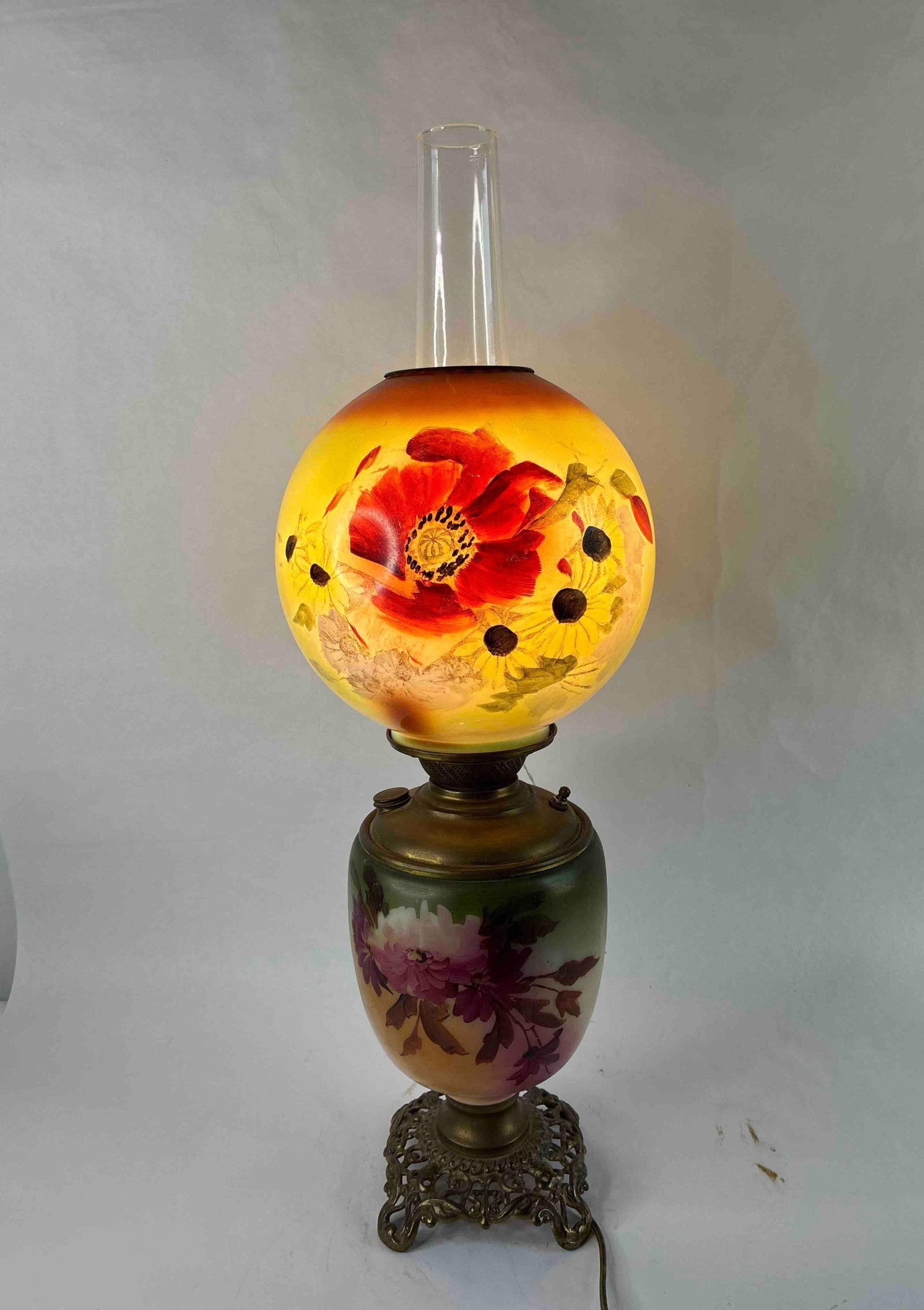 Hand Painted Floral Parlor Lamp: Marked Success to knob, once was an oil lamp but has been converted to electric. Brass body with flower decorated shade and body. 22 inches tall