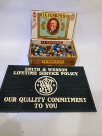 Cigar Box w/ Early Marbles and Shooters Along with a Smith & Wesson Bar Mat