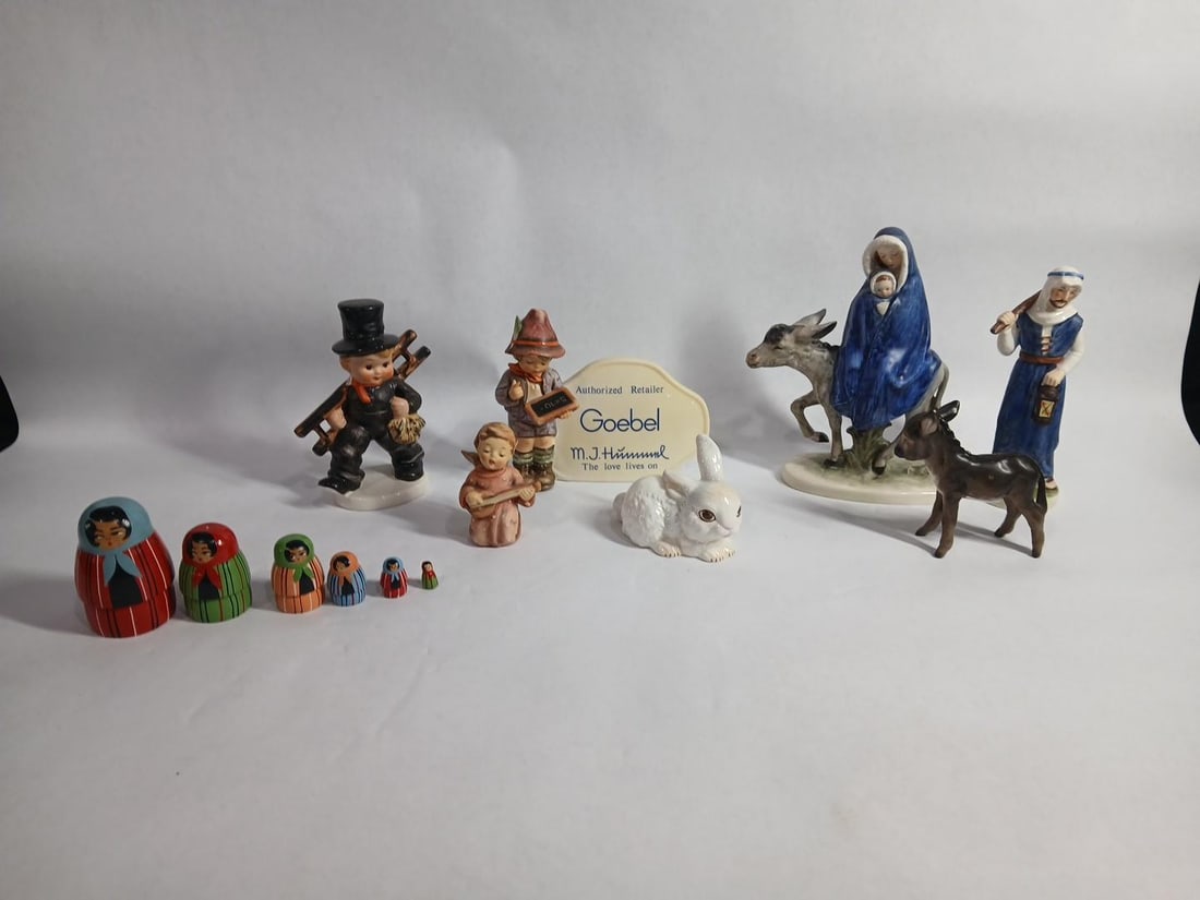 Goebel Lot of Various Figurines along with Wood German Nesting Dolls: This lot includes 7 assorted figurines along with wood nesting dolls all are in good vintage condition 