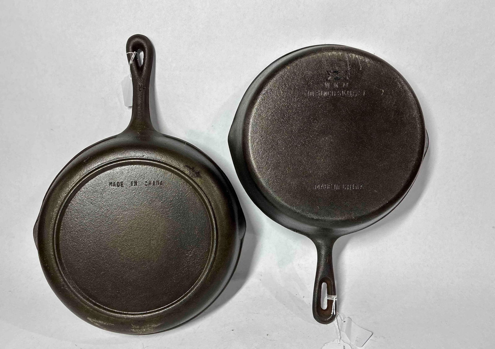 Pair of Cast Iron Skillets: 10.5 inch and 10 inch skillets, one has a heat ring