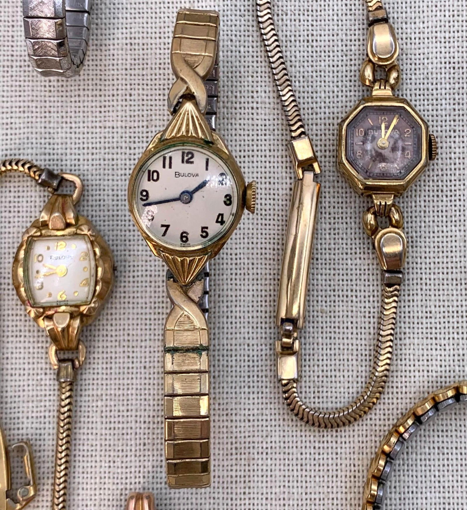 18 Elgin, Bulova, Gruen, Waltham, Caravelle, 10k Filled, 14k Rolled Gold Vintage Ladies Wristwatches: 14k Gold Filled, 10k RGP, 10k Gold filled marks on many of the watches, some missing the crown, a few without bands or in need of replacement bands, offered for repair/repurpose.