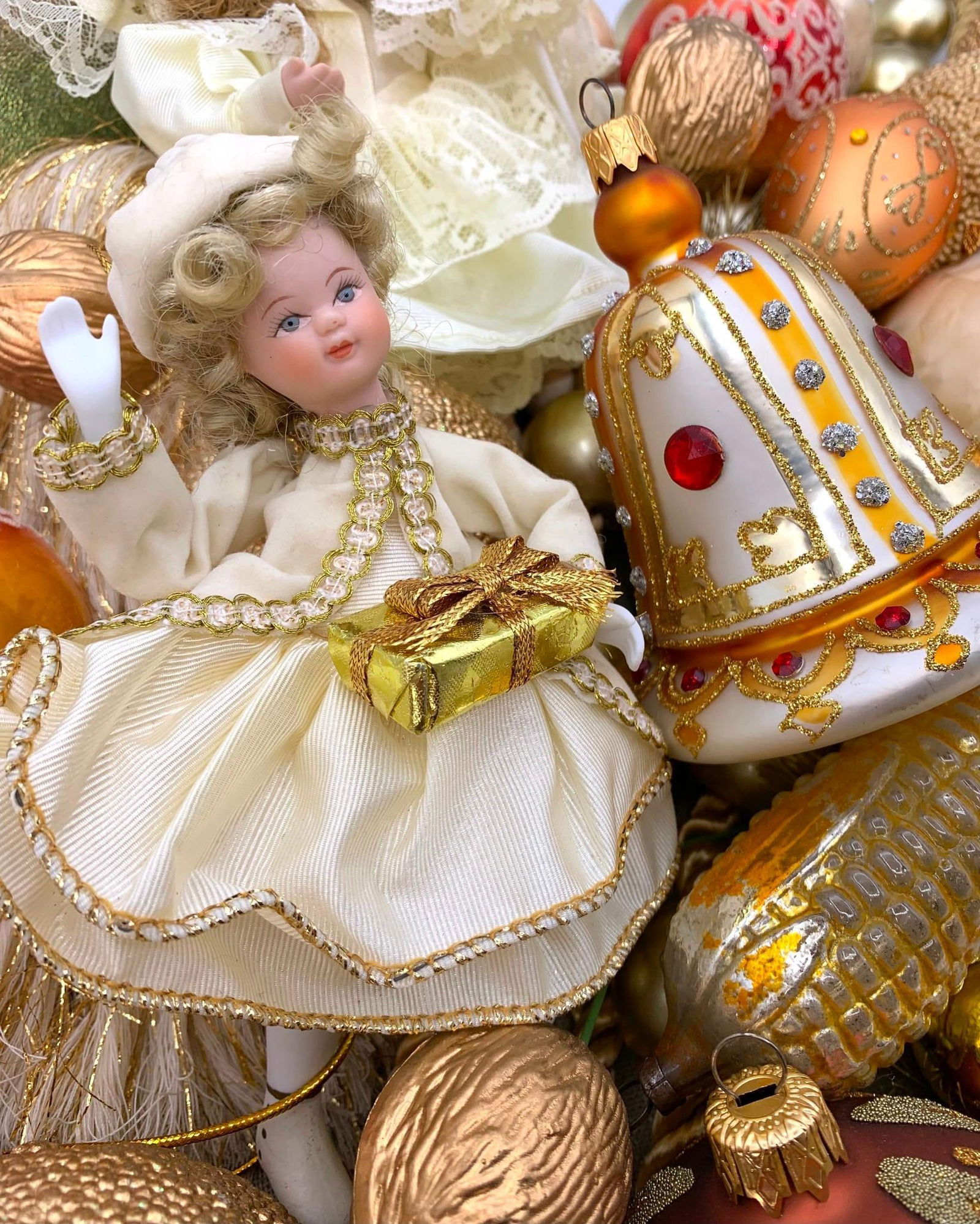 42 Antique to Vintage Jeweled Spice and Buttercream Christmas Tree Ornaments: Bisque Victorian style dolls, antique to vintage mercury glass ornaments, beaded and burnished fruit, oversize tassels, a pair of ball trimmed garland, golden faux pine and plastic walnut picks. 