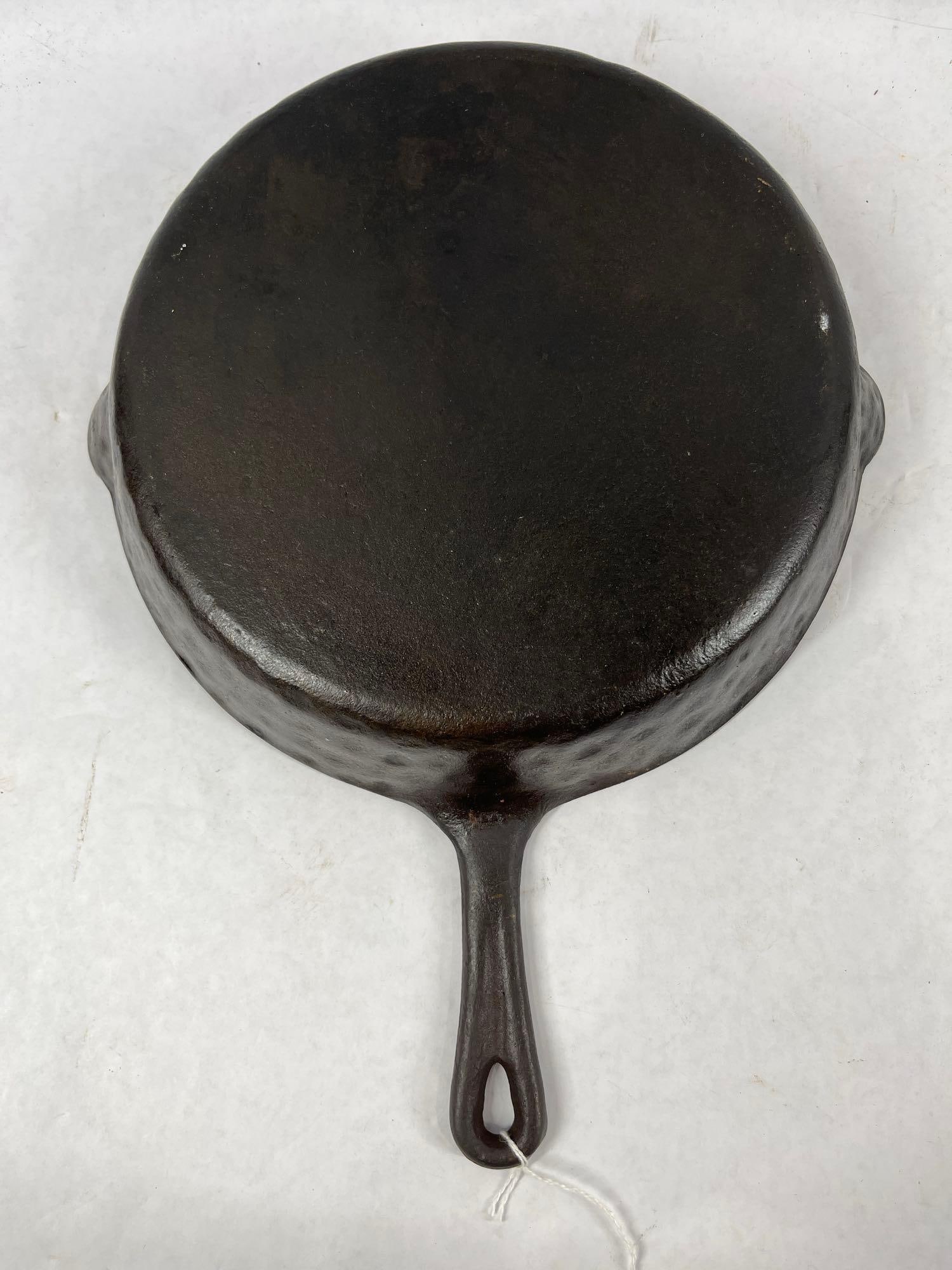 Unmarked Hammered Cast iron Skillet: No name or numbers except a small B at the base of handle on under side. 10 inch diameter with spouts.