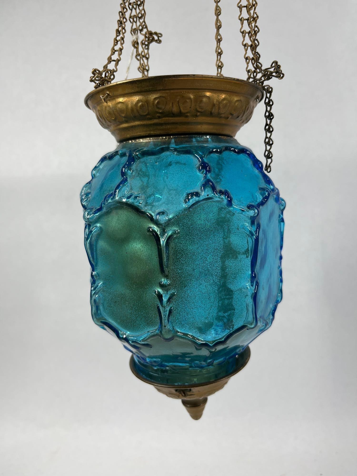 Iridescent Blue Pull Down Candle Lantern: 7 inches tall, glass shade has a few very small chips along bottom rim.