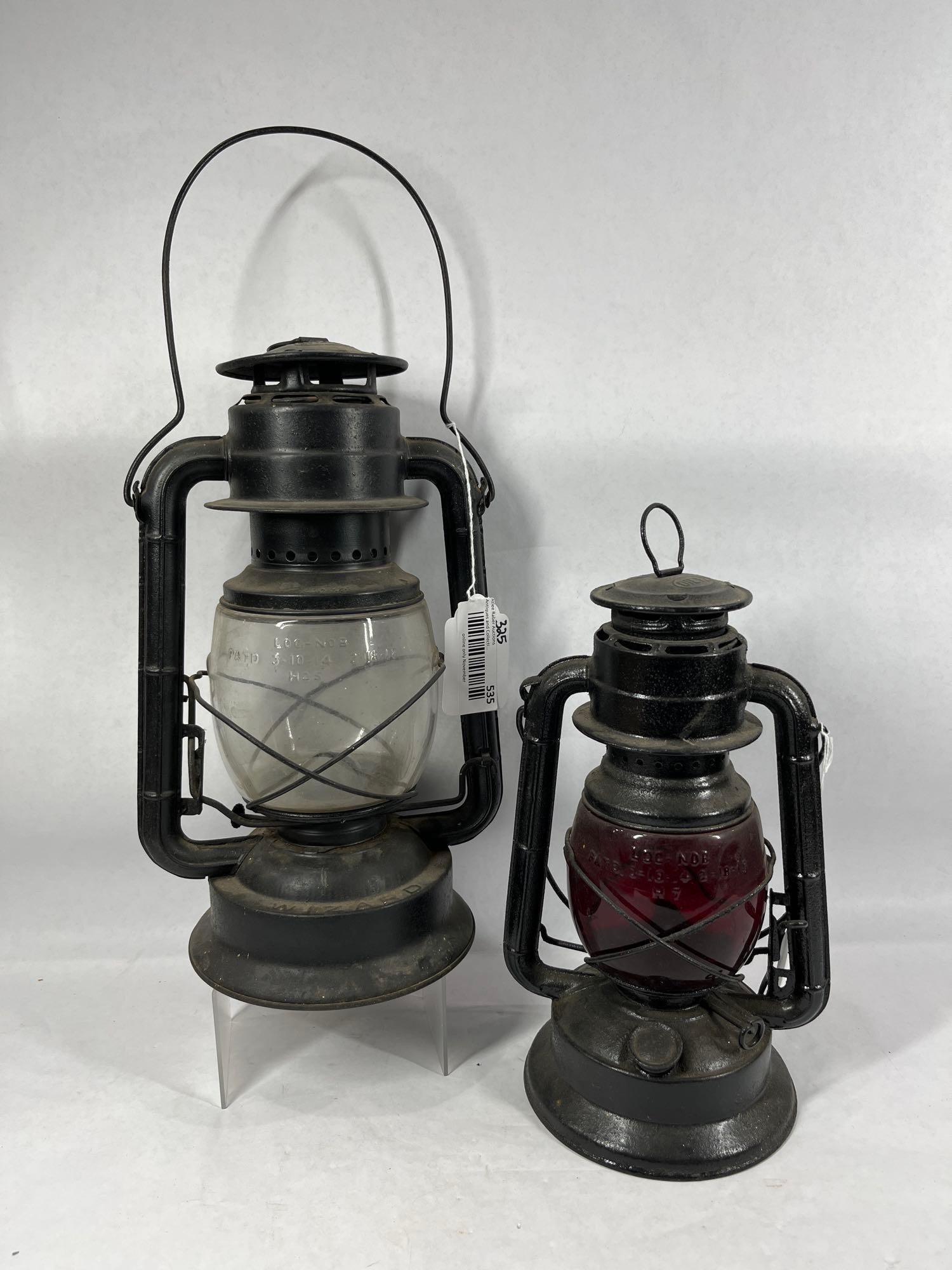 Pair of Dietz Wizard Lanterns: Little Wizard with red glass globe. Embossed NY-US. 12 inches tall. Wizard with clear glass embossed globe. Marked NY. 13 inches tall