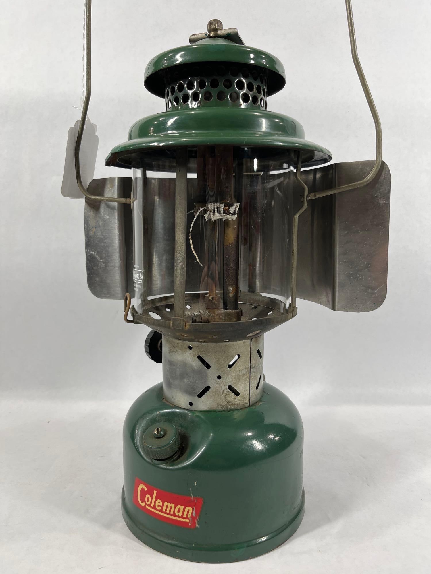 Coleman Model 228E: Double mantle and includes reflector and handle. 15 inches tall. Dated 1952