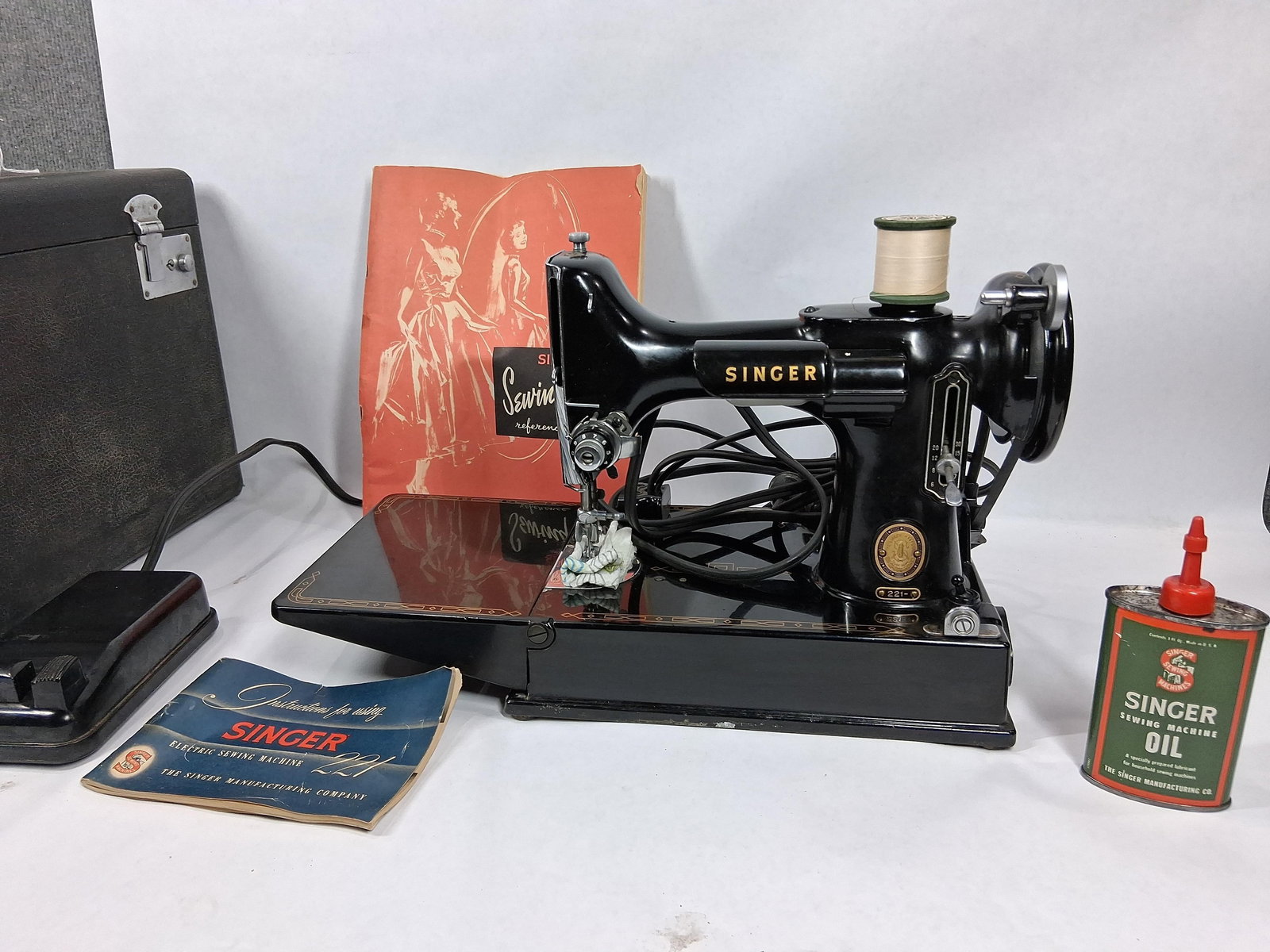 Singer featherweight sewing machine: Sewing machine works and comes with box of attachments, oiler. Is in good clean condition! Serial # AM382135. Also comes with sewing skills catalog and instruction manual.