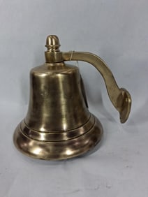 Small polished brass bell with wall bracket