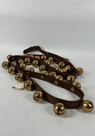 Strand of brass double throated sleigh bells