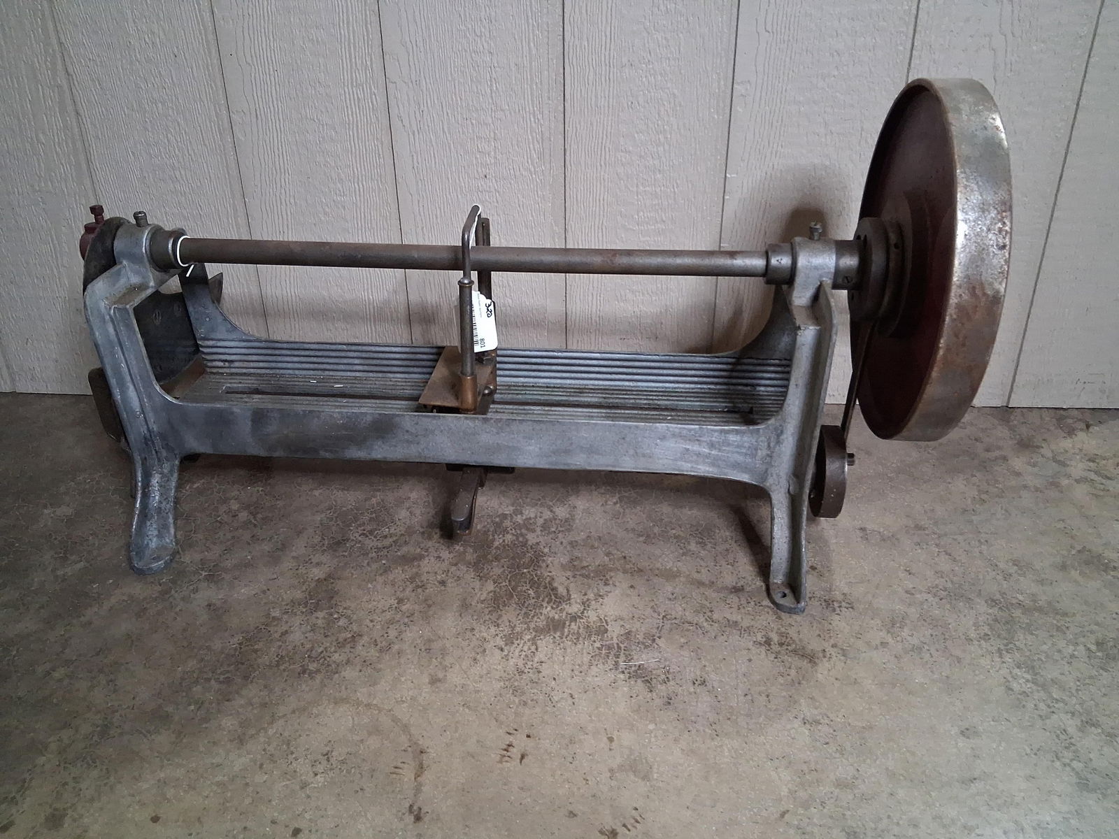 Early Hand Crank Liberty Bread Slicing Machine: Heavy cast metal industrial bread slicing machine that appears to be in good condition and seems to be functioning as it should. 35in long. Wheel is 13in diameter.