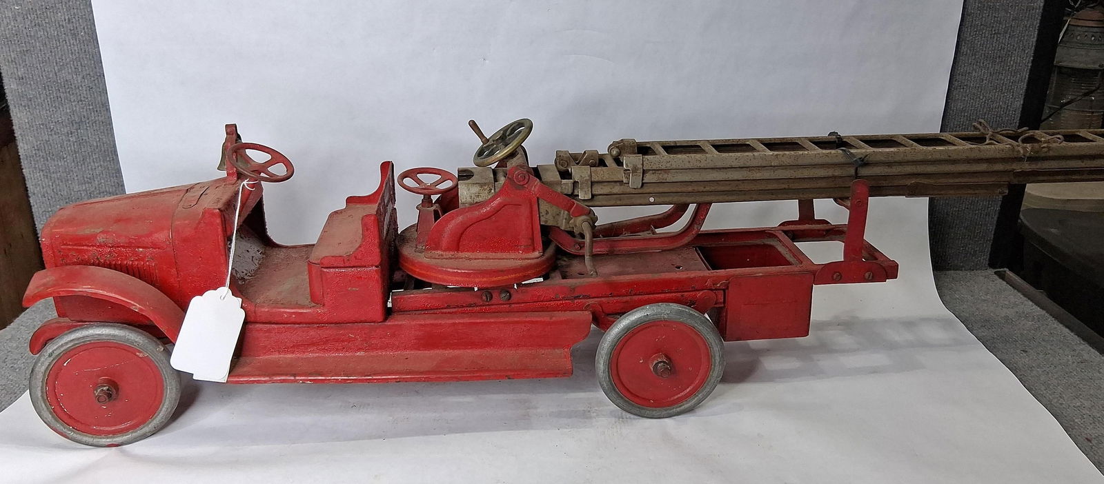 Buddy-L Aerial Ladder Fire Truck: Shows areas of peeling paint but overall is structurally sound! 39in long.